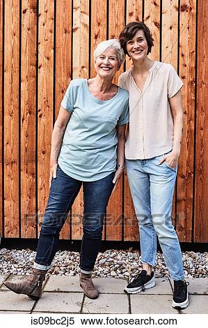 Stock Photography - Portrait of senior woman with grown daughter, outdoors, smiling. Fotosearch