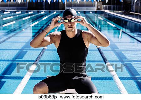 Portrait of swimmer in swimming cap and goggles View Large Photo Image Stock Photo - Portrait of swimmer in swimming cap and goggles. Fotosearch