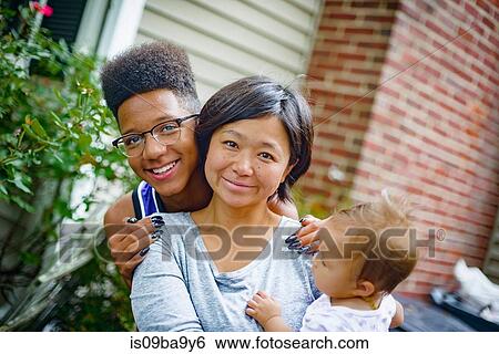 Portrait of teenage boy with mid adult woman and baby daughter View Large Photo Image Stock Photograph - Portrait of teenage boy with mid adult woman and baby daughter. Fotosearch