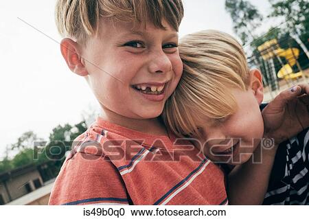Portrait of two boys in playground, smiling View Large Photo Image Stock Image - Portrait of two boys in playground, smiling. Fotosearch