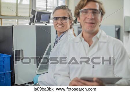 Stock Image - Portrait of two lab workers in thread factory. Fotosearch