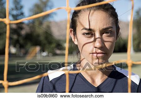 Portrait of woman behind football goal netting looking at camera View Large Photo Image Stock Image - Portrait of woman behind football goal netting looking at camera. Fotosearch