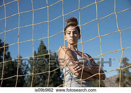 Portrait of woman behind football goal netting looking at camera View Large Photo Image Stock Image - Portrait of woman behind football goal netting looking at camera. Fotosearch