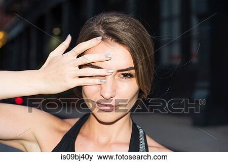 Portrait of woman, hand covering eye looking at camera, New York, USA View Large Photo Image Stock Photo - Portrait of woman, hand covering eye looking at camera, New York, USA. Fotosearch
