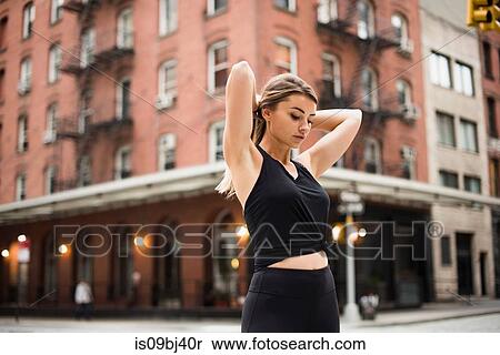 Portrait of woman hands behind head looking down, New York, USA View Large Photo Image Stock Photography - Portrait of woman hands behind head looking down, New York, USA. Fotosearch