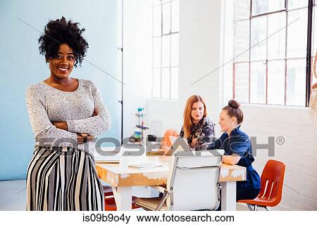 Portrait of woman in office looking at camera smiling View Large Photo Image Stock Photo - Portrait of woman in office looking at camera smiling. Fotosearch