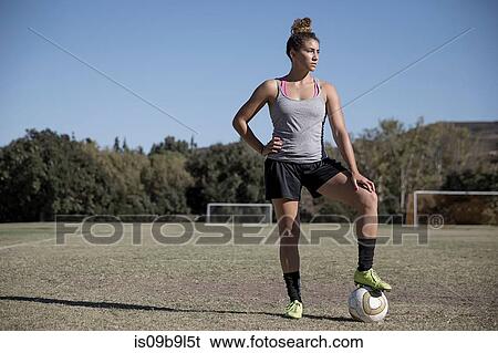Portrait of woman on football pitch looking away View Large Photo Image Stock Photograph - Portrait of woman on football pitch looking away. Fotosearch