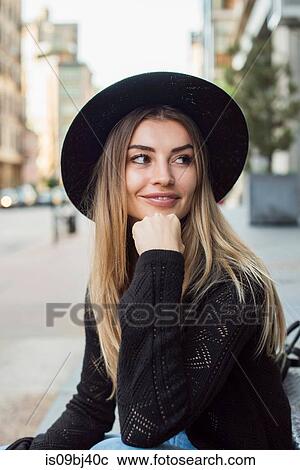 Portrait of woman wearing hat, hand on chin looking away, New York, USA View Large Photo Image Stock Image - Portrait of woman wearing hat, hand on chin looking away, New York, USA. Fotosearch