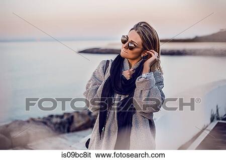 Portrait of woman wearing sunglasses looking away, Odessa, Odeska Oblast, Ukraine, Eastern Europe View Large Photo Image Stock Photograph - Portrait of woman wearing sunglasses looking away, Odessa, Odeska Oblast, Ukraine, Eastern Europe. Fotosearch
