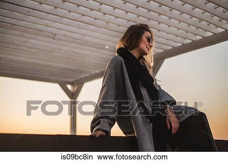 Portrait of woman wearing winter coat and sunglasses looking away, Odessa, Odeska Oblast, Ukraine View Large Photo Image Picture - Portrait of woman wearing winter coat and sunglasses looking away, Odessa, Odeska Oblast, Ukraine. Fotosearch