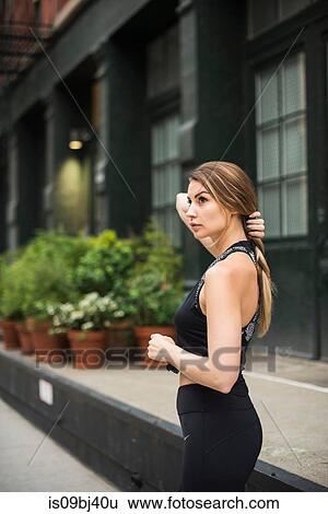 Portrait of woman wearing workout clothes looking away, New York, USA View Large Photo Image Stock Photograph - Portrait of woman wearing workout clothes looking away, New York, USA. Fotosearch