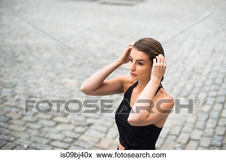 Portrait of woman with hands on head looking away, New York, USA View Large Photo Image Stock Photo - Portrait of woman with hands on head looking away, New York, USA. Fotosearch