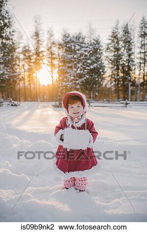 Portrait of young girl standing in snow View Large Photo Image Stock Image - Portrait of young girl standing in snow. Fotosearch