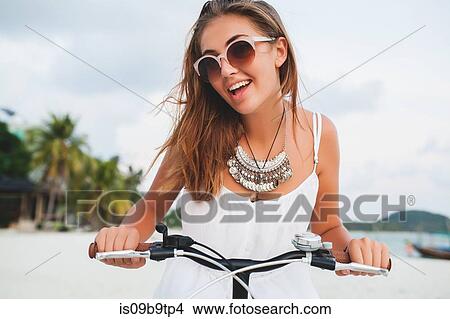 Portrait of young woman holding bicycle handlebars on sandy beach, Krabi, Thailand View Large Photo Image Picture - Portrait of young woman holding bicycle handlebars on sandy beach, Krabi, Thailand. Fotosearch