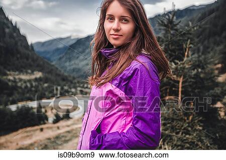 Stock Photo - Portrait of young woman near mountain highway, Draja, Vaslui, Romania. Fotosearch