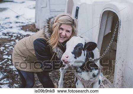 Portrait of young woman with cow, in winter landscape View Large Photo Image Stock Photo - Portrait of young woman with cow, in winter landscape. Fotosearch