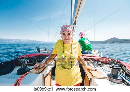 Stock Image - Portrait of young woman yachting, Croatia. Fotosearch