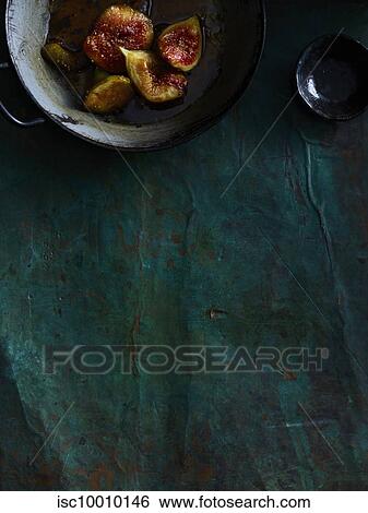 Pot of figs on textured surface View Large Photo Image Stock Photograph - Pot of figs on textured surface. Fotosearch