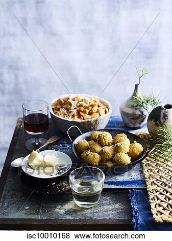 Stock Photo - Prawn salad and fritter dish served with red wine. Fotosearch