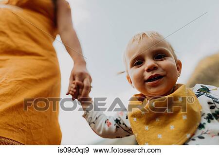 Pregnant mother holding toddler daughter's hand, low angle cropped portrait, Mineral King, California, USA View Large Photo Image Stock Photo - Pregnant mother holding toddler daughter's hand, low angle cropped portrait, Mineral King, California, USA. Fotosearch
