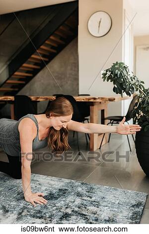 Stock Photograph - Pregnant woman doing balancing exercise. Fotosearch