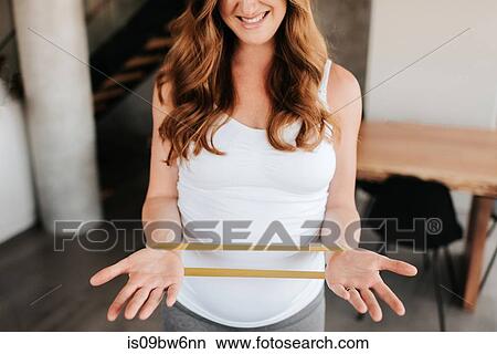 Pregnant woman doing strengthening exercise with bands View Large Photo Image Picture - Pregnant woman doing strengthening exercise with bands. Fotosearch