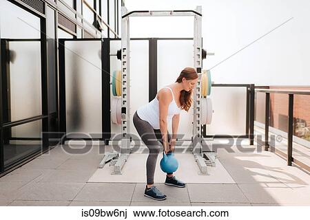 Pregnant woman exercising with kettle bell on balcony View Large Photo Image Stock Image - Pregnant woman exercising with kettle bell on balcony. Fotosearch
