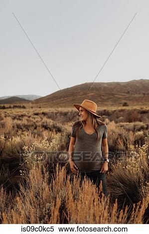 Stock Photography - Pregnant woman in field landscape, Kennedy Meadows, California, US. Fotosearch