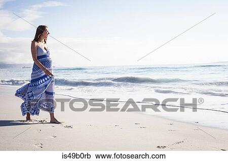 Stock Image - Pregnant woman on beach, Cape Town, South Africa. Fotosearch