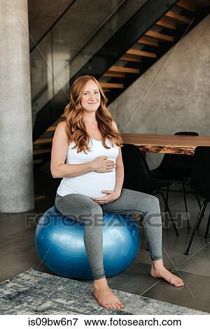 Pregnant woman on exercise ball View Large Photo Image Stock Photo - Pregnant woman on exercise ball. Fotosearch