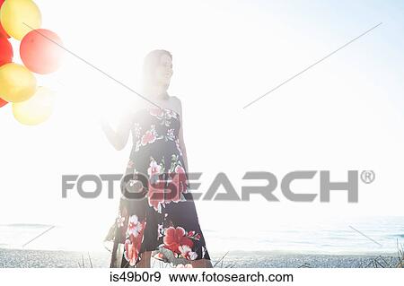 Stock Photo - Pregnant woman with balloons, Cape Town, South Africa. Fotosearch