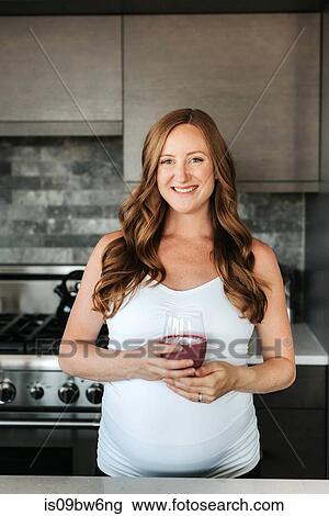 Pregnant woman with glass of smoothie View Large Photo Image Stock Image - Pregnant woman with glass of smoothie. Fotosearch