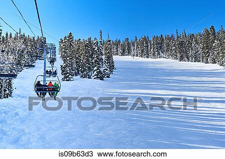 Rear view of skiers on ski lift moving up snow covered landscape, Aspen, Colorado, USA View Large Photo Image Stock Image - Rear view of skiers on ski lift moving up snow covered landscape, Aspen, Colorado, USA. Fotosearch