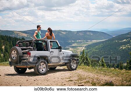 Road trip couple in four wheel convertible in Rocky mountains, Breckenridge, Colorado, USA View Large Photo Image Stock Photograph - Road trip couple in four wheel convertible in Rocky mountains, Breckenridge, Colorado, USA. Fotosearch