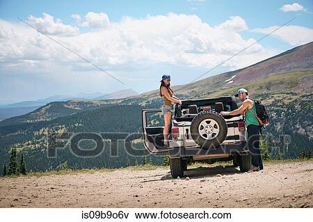 Road trip couple unpacking four wheel convertible in Rocky mountains, Breckenridge, Colorado, USA View Large Photo Image Stock Photo - Road trip couple unpacking four wheel convertible in Rocky mountains, Breckenridge, Colorado, USA. Fotosearch