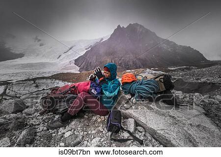Rock climber by climbing equipment shielding from extreme weather, El Chaltn, south Patagonia, Argentina View Large Photo Image Picture - Rock climber by climbing equipment shielding from extreme weather, El Chaltn, south Patagonia, Argentina. Fotosearch
