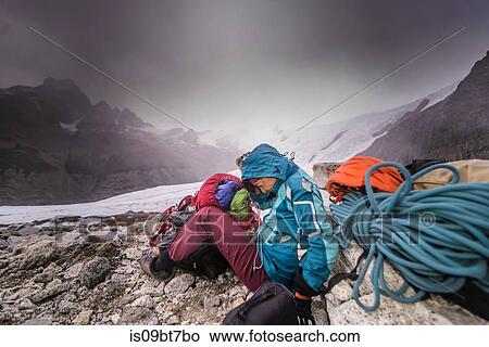 Rock climber by climbing equipment shielding from extreme weather, El Chaltn, south Patagonia, Argentina View Large Photo Image Picture - Rock climber by climbing equipment shielding from extreme weather, El Chaltn, south Patagonia, Argentina. Fotosearch
