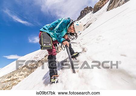 Stock Image - Rock climber in snowy slope, El Chaltn, south Patagonia, Argentina. Fotosearch