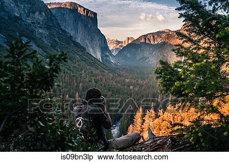 Rock climber taking photograph of mountain ranges, Yosemite National Park, California, USA View Large Photo Image Stock Photography - Rock climber taking photograph of mountain ranges, Yosemite National Park, California, USA. Fotosearch