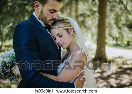 Romantic bride and groom hugging each other in woodland View Large Photo Image Stock Image - Romantic bride and groom hugging each other in woodland. Fotosearch