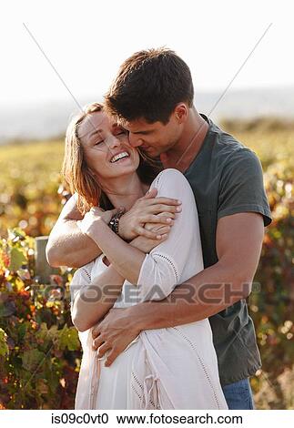 Stock Image - Romantic couple in vineyard, Cape Town, South Africa. Fotosearch