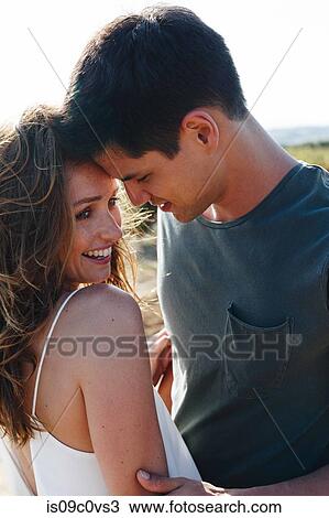 Romantic couple nuzzling in an embrace View Large Photo Image Stock Image - Romantic couple nuzzling in an embrace. Fotosearch