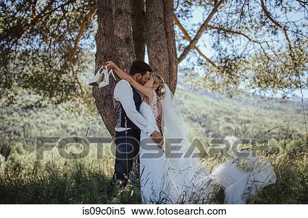 Romantic couple on wedding day kissing in woodland, Stresa, Piemonte, Italy View Large Photo Image Stock Photography - Romantic couple on wedding day kissing in woodland, Stresa, Piemonte, Italy. Fotosearch