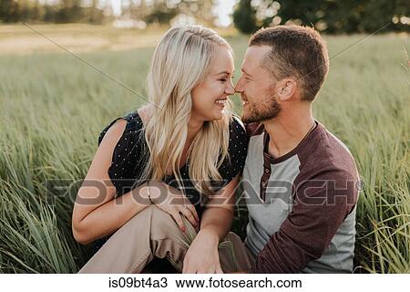 Romantic man and girlfriend face to face in field of long grass View Large Photo Image Stock Image - Romantic man and girlfriend face to face in field of long grass. Fotosearch