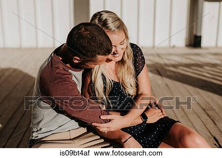 Romantic man and girlfriend sitting on porch hugging each other View Large Photo Image Stock Image - Romantic man and girlfriend sitting on porch hugging each other. Fotosearch