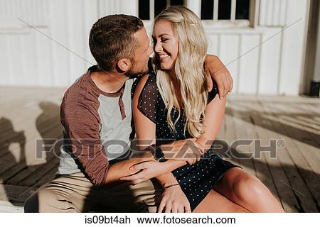 Romantic man and girlfriend sitting on porch gazing at each other View Large Photo Image Stock Image - Romantic man and girlfriend sitting on porch gazing at each other. Fotosearch