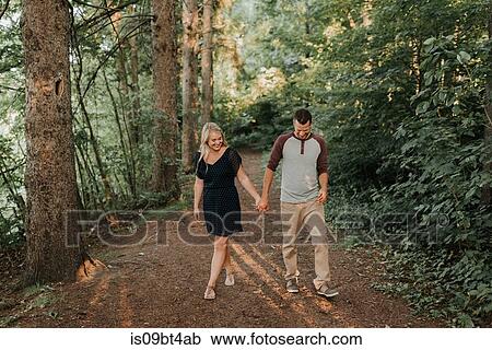 Romantic man and girlfriend strolling in woodland View Large Photo Image Stock Image - Romantic man and girlfriend strolling in woodland. Fotosearch