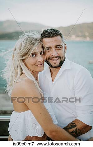 Romantic mid adult couple hugging on lakeside, portrait, Stresa, Piemonte, Italy View Large Photo Image Stock Photo - Romantic mid adult couple hugging on lakeside, portrait, Stresa, Piemonte, Italy. Fotosearch