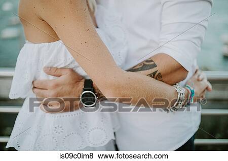 Romantic mid adult couple hugging on lakeside, mid section View Large Photo Image Stock Photo - Romantic mid adult couple hugging on lakeside, mid section. Fotosearch
