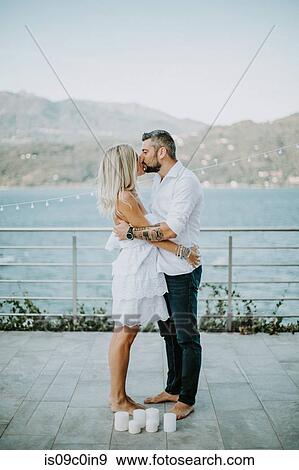 Romantic mid adult couple kissing on lakeside, Stresa, Piemonte, Italy View Large Photo Image Stock Photo - Romantic mid adult couple kissing on lakeside, Stresa, Piemonte, Italy. Fotosearch
